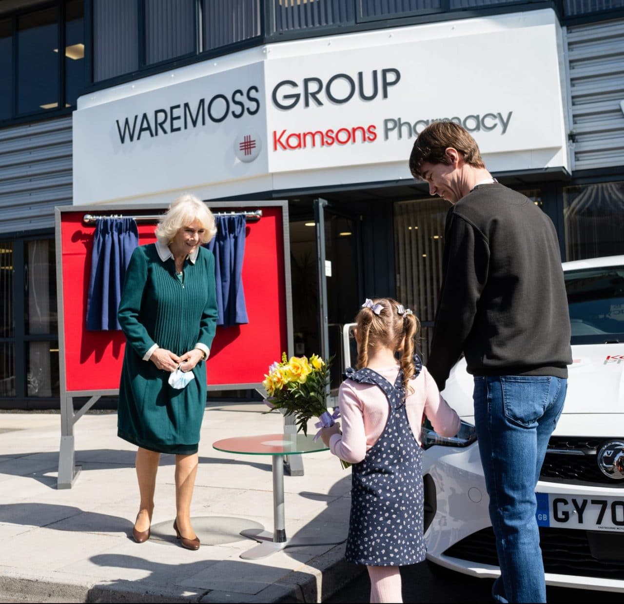 HRH The Duchess of Cornwall being presented flowers at Kamsons Pharmacy Head Office