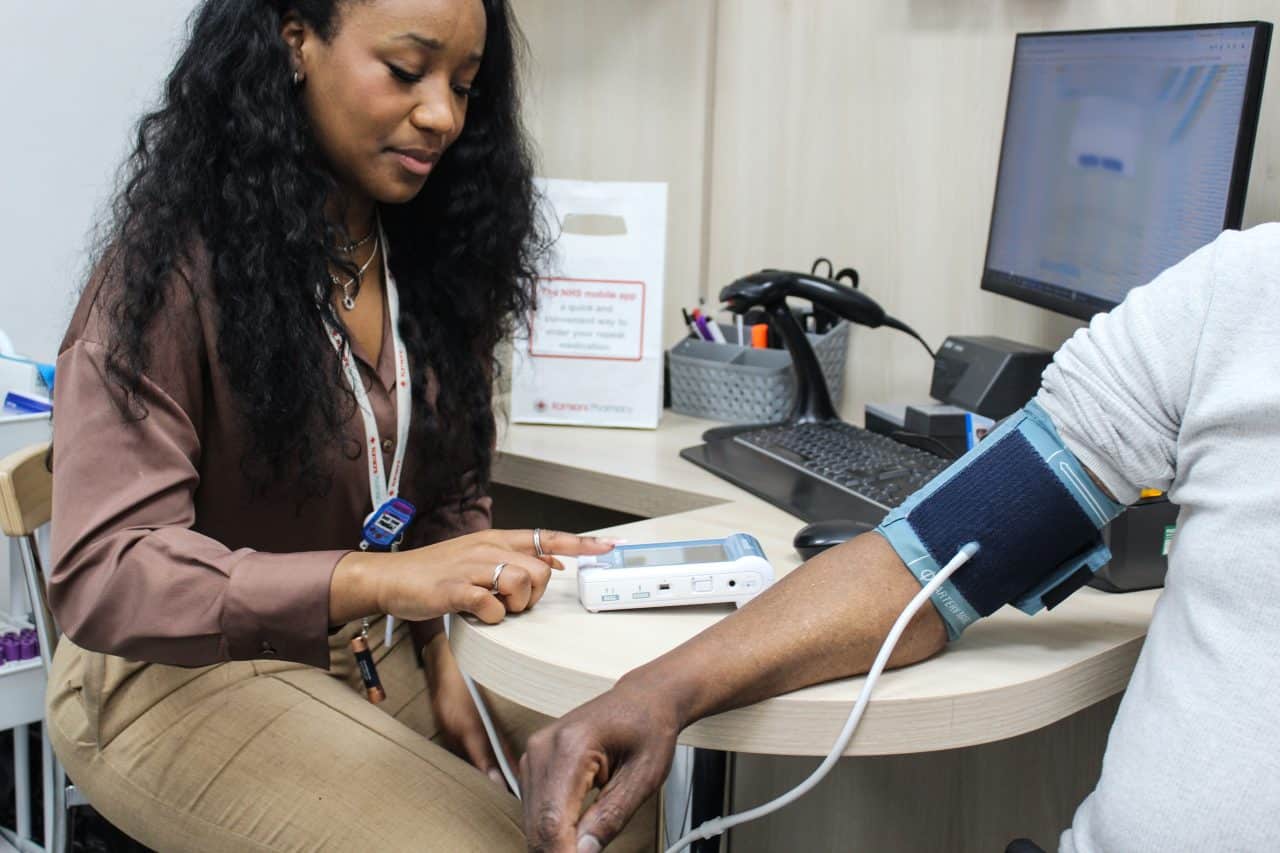 image of Kamsons pharmacist taking a patients blood pressure reading